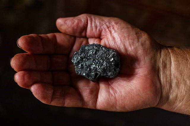 National Energy Guarantee revival could lock in coal such as shown in hand here