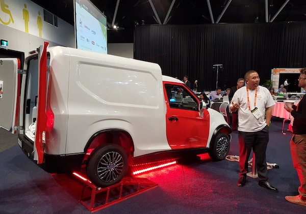 ACE Cargo EV with designer Will Qiang talking to an attendee at SEC 2019.