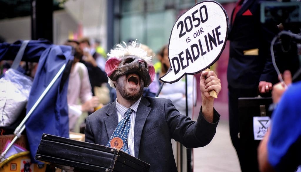 COP26 activist with climate change sign
