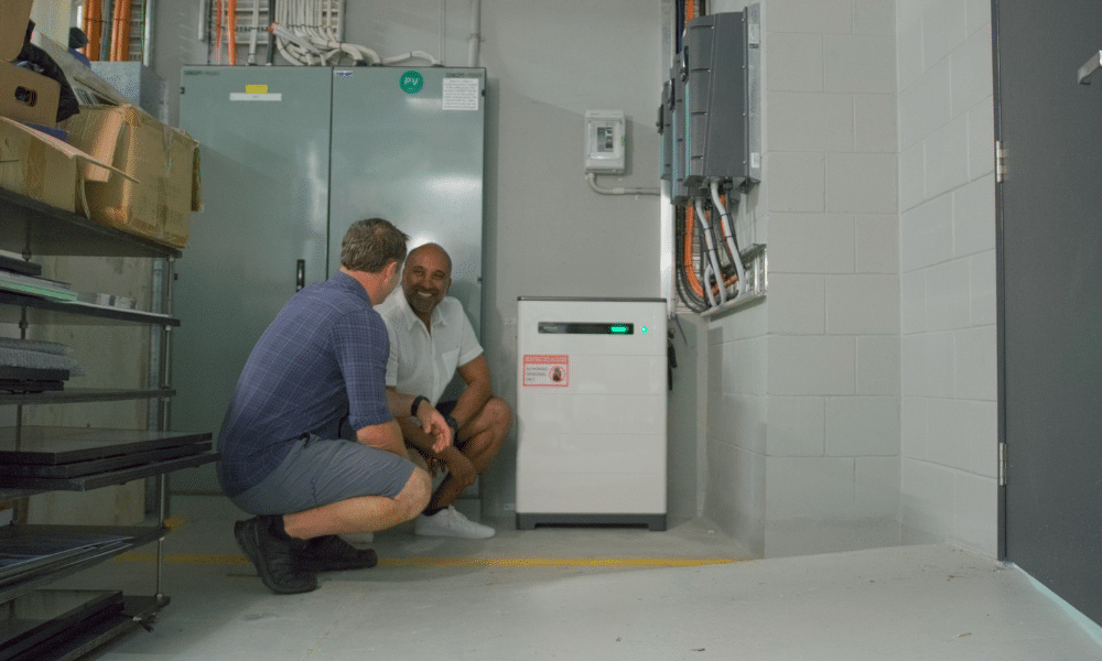 Roshan and Dean inspecting the GoodWe battery