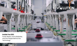 Battery production line in a high-tech facility with Global Energy Revolution branding; a white speech bubble in the corner contains 'Inside Fox ESS: Power Beast, Home Batteries, and the People Behind the Technology.' Battery production line in a high-tech facility with Global Energy Revolution branding; a white speech bubble in the corner contains 'Inside Fox ESS: Power Beast, Home Batteries, and the People Behind the Technology.'