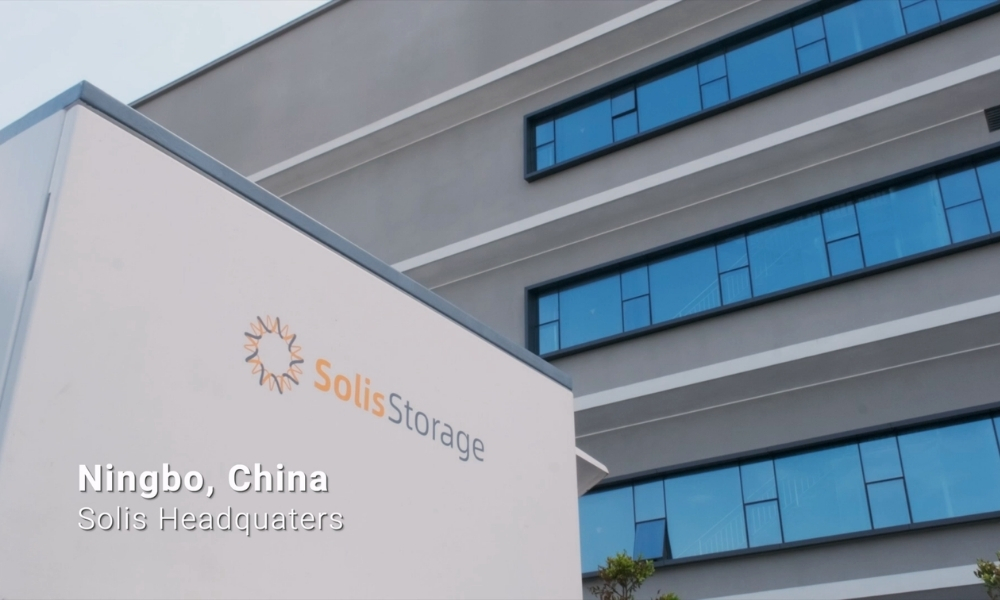 Exterior view of Solis Storage headquarters in Ningbo, China, with a white sign bearing the SolisStorage logo and a modern gray building with blue-tinted windows in the background. Exterior view of Solis Storage headquarters in Ningbo, China, with a white sign bearing the SolisStorage logo and a modern gray building with blue-tinted windows in the background.